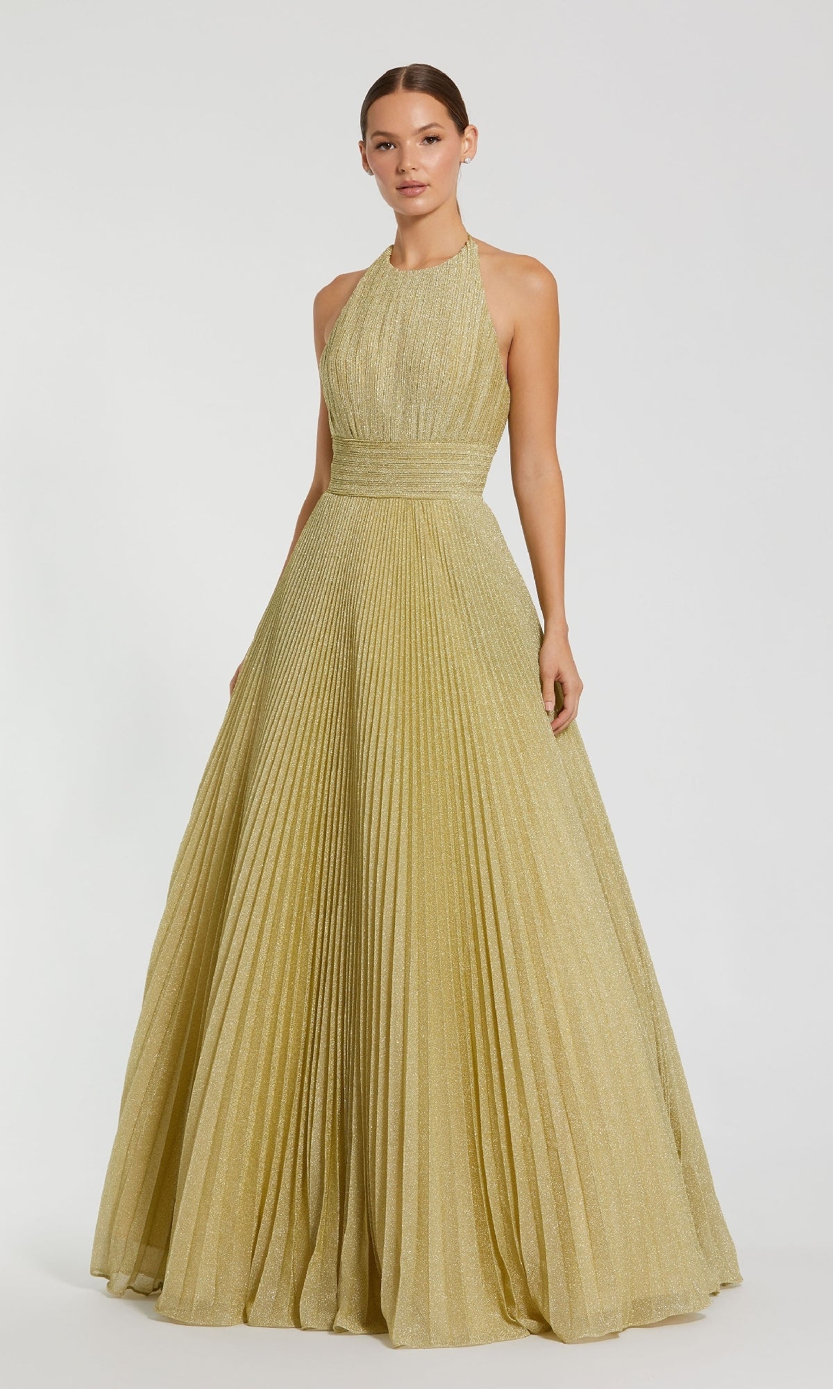 A woman wears the Mac Duggal 30772 Pleated Long Gold Formal Dress, featuring a sleeveless design and fitted waist, standing against a plain white background.